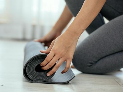 Close-up of hands on a yoga mat, ready for a push-up.