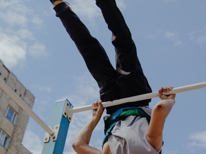 Man in a focused stance during a bodyweight exercise.